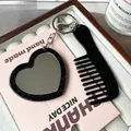 Glittery black heart mirror and small comb keychain set on a pink decorative card - Black
