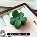 Matte dark green flower hair claw clip measuring 4x4cm on white velvet display - Dark Green