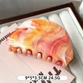 Elegant oval hair claw clip with orange and pink marble pattern in 9x5x3.5cm size - Smudged Orange Pink