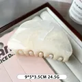 Elegant oval marbled acetic acid hair claw clip in creamy white finish, size 9x5x3.5cm - Off White