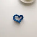 Detail of a matte navy blue heart-shaped claw clip with anti-slip teeth on white surface - Navy Heart