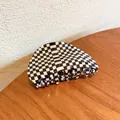 Semi-circular black and white checkerboard hair claw clip in a glossy finish - Black