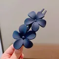 Detail of matte navy blue double flower hair clip with secure internal teeth structure - Navy Blue