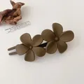 Detail view of a matte dark brown double flower hair clip with a minimalist forest style - Dark Coffee