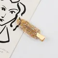 Amberkleurige hars haarklem met glitter pailletten op goudkleurig metaal - Bruin