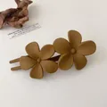 Close-up of caramel matte flower hair clip on a minimalist cream-colored background - Light Coffee