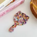 Cat-shaped tortoiseshell acetate hand mirror with colorful marble pattern and slim handle - Rainbow