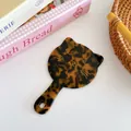 Cat shaped handheld makeup mirror in brown tortoiseshell pattern with hanging hole - Tortoiseshell