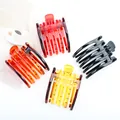 Lot de quatre grandes pinces à cheveux brillantes noires, ambre et rouges sur fond esthétique - Lot de 4 / Rouge, Noir, Ambre foncé, Ambre clair