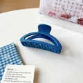 Matte Klein blue minimalist geometric hair claw clip for women on a decorative background - Dark Blue Moon
