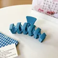 Matte Klein blue claw clip for hair with minimalist twist design on white table - Light Blue Ripples