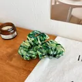 Elegant monstera leaf hair claw clip with green marble texture and silver leaf veins - Metallic Green