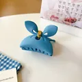 Matte sky blue bow hair claw clip with golden spring on a minimalist white desk - Light Blue Butterfly