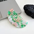 Acetate hair comb with green and pink marble texture in a crescent geometric shape - Green