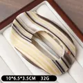 Elegant marble cream acetate hair claw clip with golden logo and hollow oval design - Grey Black Striped