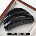 Minimalist black glossy silicone hair claw clip in a half-moon hollow design for women - Bright Black