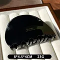 Polished black acetate shark hair claw clip with gold lettering for elegant styling - Black