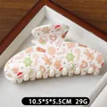 Off-white Christmas hair claw clip with festive Santa and snowman patterns, 10.5cm size - Brown Gloves Pattern