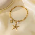 Bracelet en acier inoxydable plaqué or 18k avec pendentifs étoile de mer et perle - Bracelet Perle Artificielle Étoile de Mer Coquillage (E154) / Or