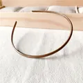 Detailed view of brown plastic headband featuring anti-slip teeth and glossy finish - Light Coffee