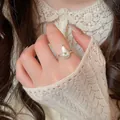 Close-up of a pear-shaped silver frosted ring with a yellow star zircon on a model's hand - Silver Frosted Pear Star Style (29#)