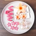 Rosa Haarklammer und orangefarbene Frangipani-Clips in einer Schale auf Holzgrund - Orange Series Hair Accessory Set / Orange