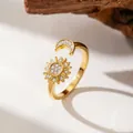 Detailed close-up of golden sun and moon open ring set with sparkling zircons. - Sun Moon Style Gold (F1254)