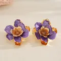 Statement purple enamel and gold-toned metallic flower rings with elegant textured petals. - Earrings / Purple