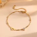 Close-up of gold-plated stainless steel bracelet with heart charms and clear cubic zirconia - Hollow Rhinestone Solid Heart Style (N213)