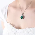 Silver titanium steel necklace featuring a round emerald green crystal pendant - Silver Green Glass Stone