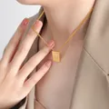Gold square necklace with letter N pendant on minimalist chain worn by a model - Letter N Style (P1506-N)