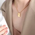 Golden square letter Q pendant necklace on model with polished stainless steel chain - Letter Q Style (P1506-Q)