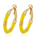 Close-up detail of yellow enamel bamboo joint stainless steel gold hoop earrings for women - Yellow
