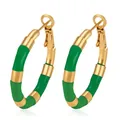 Close-up of gold stainless steel hoop earrings with green enamel bamboo design - Green