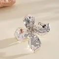 Close-up of a silver metallic crumpled flower ring with hammered texture detail - Ring / Silver