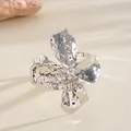 Close-up of silver crinkled metal flower cuff bracelet with hammered texture - Bangle / Silver