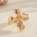 Detailed close-up of a gold metallic wrinkled flower ring featuring hammered petals - Ring / Gold