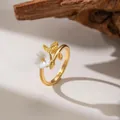 Detail shot of elegant gold flower ring with white shell petals and leaf design - White Shell Flower (F1242)