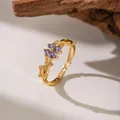 Detail view of adjustable golden vine ring with purple four-petal crystal flower - Purple Zirconia Plum Blossom (F1166) / Gold