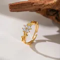 Detailed view of a gold adjustable flower ring with sparkling clear zircon crystals. - White Zirconia Plum Blossom (F1266)