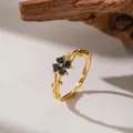 Macro detail of adjustable gold plum blossom ring with dark gemstones and vine design - Black Zirconia Plum Blossom (F1268)