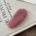 Close-up of pink-purple plush BB hair clip on a vintage linen fabric background - Dusty Pink