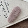 Detailed macro view of a large plush teardrop-shaped hair clip in soft brown faux fur - Lavender