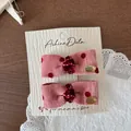 Pink corduroy bow hair clips with red polka dots and gold metallic detail on card - Bow Clip Pair