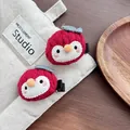 Detailed view of handmade red crochet penguin hair clips with soft knit texture - Penguin / Red