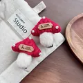 Detail of handmade knit mushroom hair clips with pearls and reindeer leather patch - Mushroom / Red