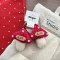 Detailed view of hand-knitted mushroom hair ties with white beads and red yarn texture - Mushroom Style