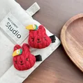 Close-up of red crochet rabbit hair clips with carrot and pearl details on linen - Little Rabbit / Red
