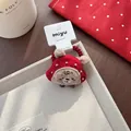Detail of red plush bear hair tie with golden bead accents on a textured tray - Red Beaded Bear Style / Hair Tie