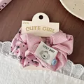 Detail of pink plaid and polka dot scrunchie with cute dog label and blue button - Pink Bow